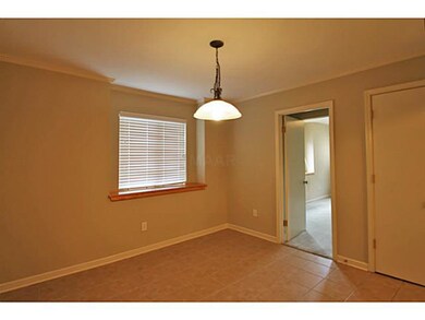 The dining room with bronze lighting fixture and t