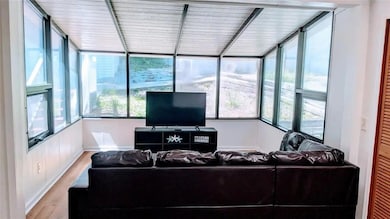 Living room featuring wood finished floors and baseboards