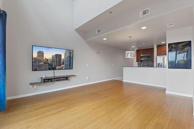 Unfurnished living room with baseboards, light wo