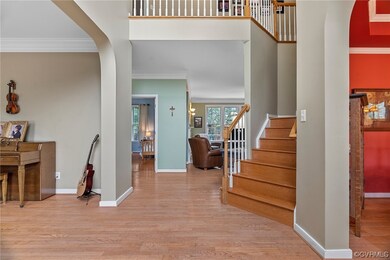 Two story foyer and beautiful stairway.