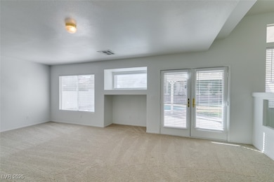 Empty room featuring light carpet and baseboards