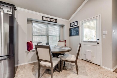 Tiled breakfast nook with crown molding