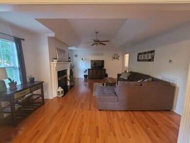 Large living room with fireplace for entertaining.