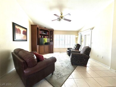 Living area with vaulted ceiling, baseboards, ceil