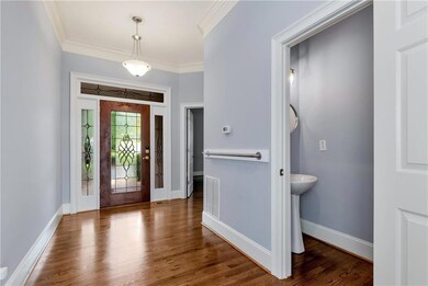 Entrance foyer featuring ornamental molding and wood finished floors