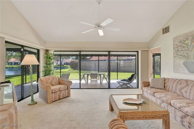 Carpeted living area featuring high vaulted ceilin