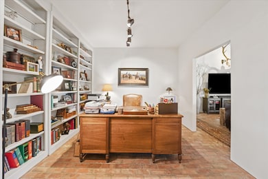 Office space with brick flooring and rail lighting