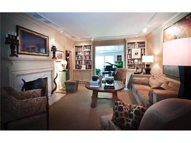 The Librairy/Den opens to the stair hall to the right and to the Sunroom to the rear.  The fireplace is a vented gas log, and that's a TV above in a picture frame with surround sound.  The first floor powder bath is to the left.  You won't believe it