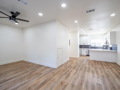 Unfurnished living room with light wood-type floo