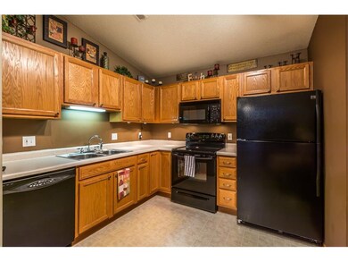 Warm wall colors make the black kitchen appliances