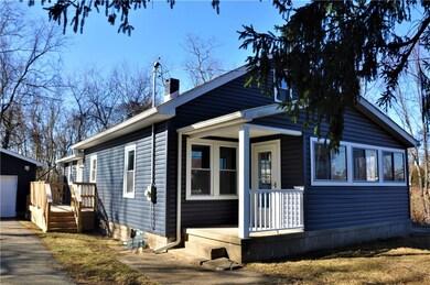Front view showing bonus enclosed porch.
