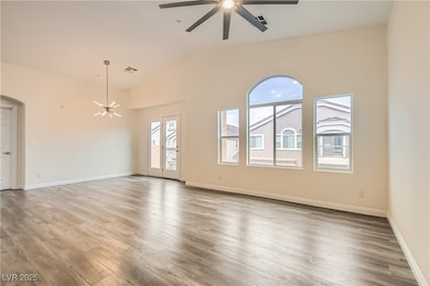 Spare room featuring a ceiling fan, lofted ceiling
