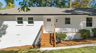 Ranch-style home featuring brick siding and a shingled roof