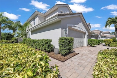 View of side of property with an attached garage and stucco siding