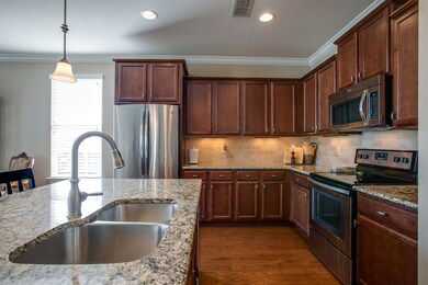 The wood cabinets have crown molding and all of the stainless steel appliances remain with the home.  