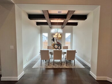 Formal dining room with STUNNING cedar-wood beams add a special touch.