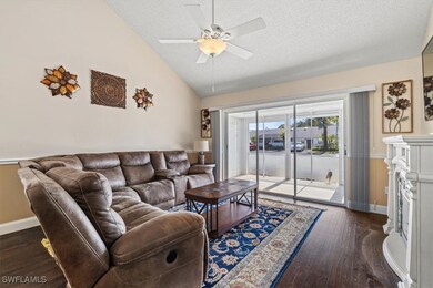 Living room with a textured ceiling, ceiling fan,