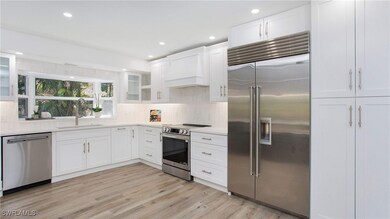 Kitchen featuring glass insert cabinets, a sink, a