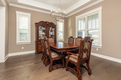 Dining room with ornamental molding, an inviting c