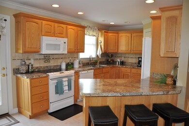 Kitchen offers custom cabinets and back splash.