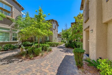 Courtyard entry with wrought iron fence, pavers an