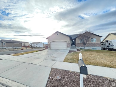 Ranch-style home with concrete driveway, a residential view, an attached garage, a front lawn, and brick siding