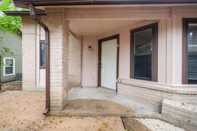 Entrance to property featuring brick siding and c