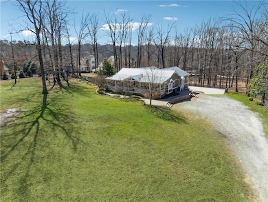 Aerial view featuring a wooded view