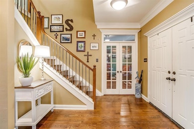 Double front doors and an incredible staircase acc