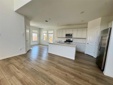 Kitchen featuring tasteful backsplash, wood finish