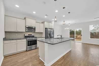 Kitchen featuring decorative light fixtures, sink,
