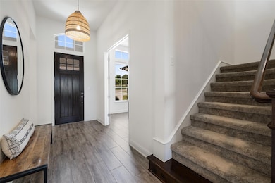 Foyer entrance featuring dark wood-style flooring
