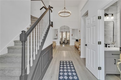 Foyer with decorative columns, a notable chandelie
