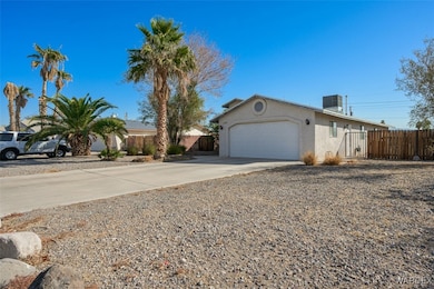 Single story home with cooling unit and a garage