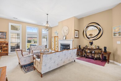 Living room with baseboards, a chandelier, visible