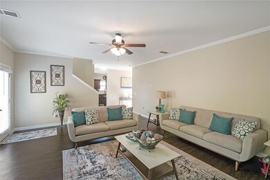 Living room with visible vents, baseboards, dark w