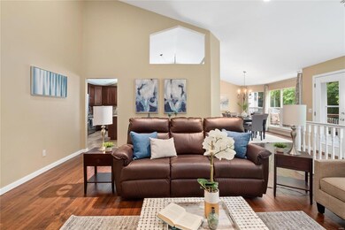 Great room with vaulted ceiling, hardwood flooring