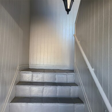 Gray tones & tiled, with a split stairway to entry