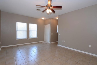Spare room featuring a ceiling fan and light tile