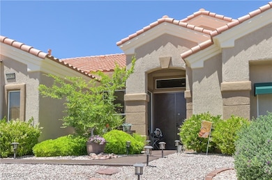 Entrance to property featuring a tile roof and stu