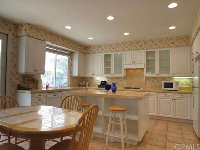Large kitchen with white cabinets and appliances a