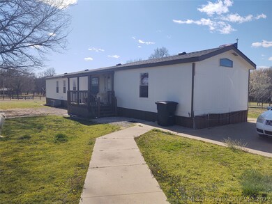 Back of house with covered porch