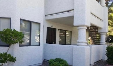 View of side of property with stairway and stucco