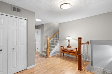 Staircase featuring wood finished floors