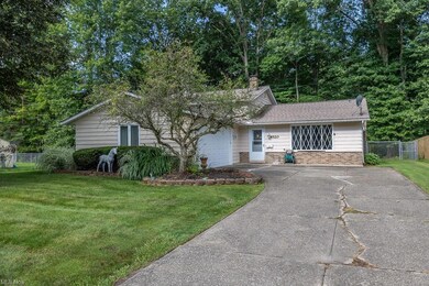 View of front facade with a front yard and garage