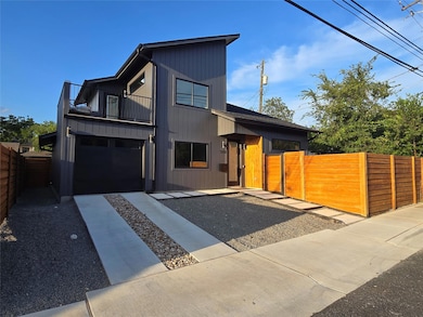 Modern home with a balcony, a gate, a garage, and