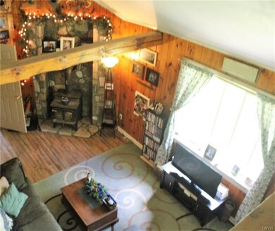 Stonework fireplace and exposed beams in cozy livi