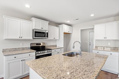 Kitchen featuring stainless steel appliances, a si