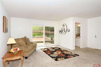 Family room with 1/2 bath looks out to the back ya