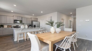 Dining space featuring dark hardwood / wood-style floors and sink